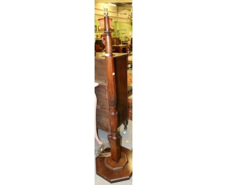 ~ A Carved Mahogany Standard Lamp, the canted column support with square form base and raised on an octagonal shaped platform