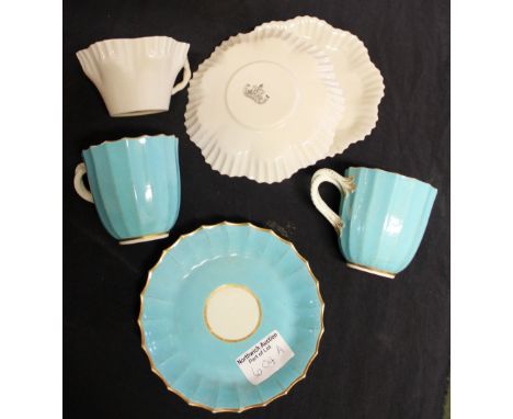 Pair of early Worcester blue plaited handled cups and one saucer and Belleek example