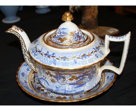 Large blue, white and gilt teapot and saucer