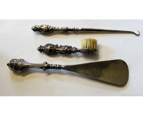 Three hallmarked silver handled items, toothbrush, button hook and shoe horn