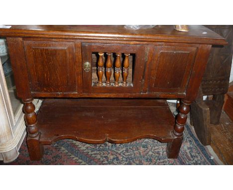 18th c. oak low cupboard, the central door having turned spindles standing on bobbin turned legs with shaped undertier, 33" w