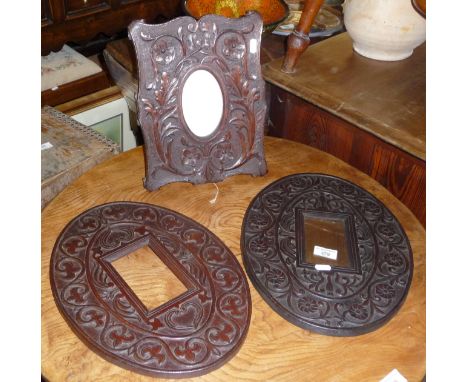 Three Arts &amp; Crafts carved oak frames, one on easel stand