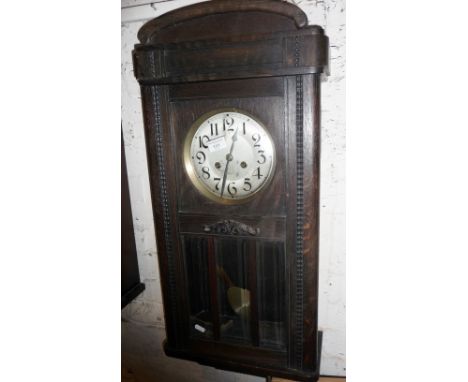 Oak cased 8-day wall clock, striking on a gong with glass door enclosing pendulum