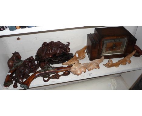 Two replica flintlock pistols, a pair of carved water buffaloes, other carvings and a mantle clock