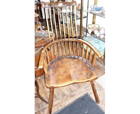 18th/19th c. ash and elm comb back Windsor armchair with saddle block seat on splayed peg legs