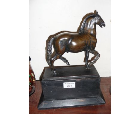 A bronze figure of a walking horse, after the antique, 20cm high on wooden plinth, overall height 31cm