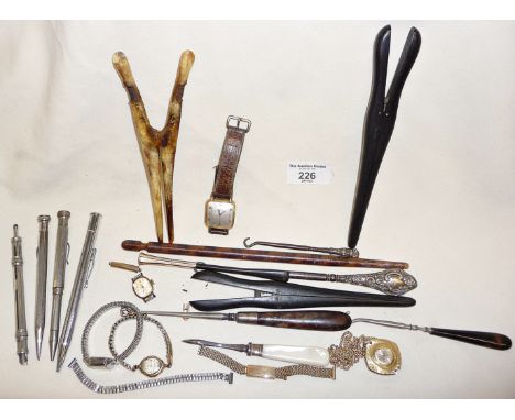Four various antique propelling pencils, wrist watches, button hooks and glove stretchers