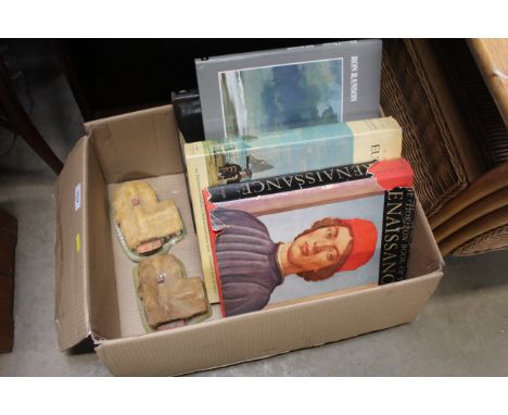 A box of art books and two cottage ornaments