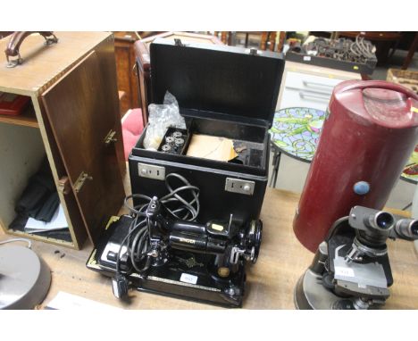 A Singer sewing machine and carrying case, sold as a collectors item