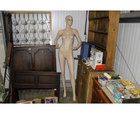 A full size female mannequin model mounted to base