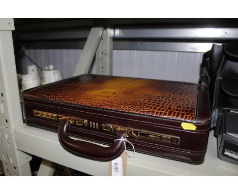 A faux crocodile skin briefcase 