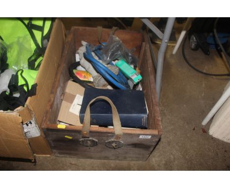 A wooden box containing various items to include plumbing parts, cast concrete garden gnome, Phillips and other light bulbs, 