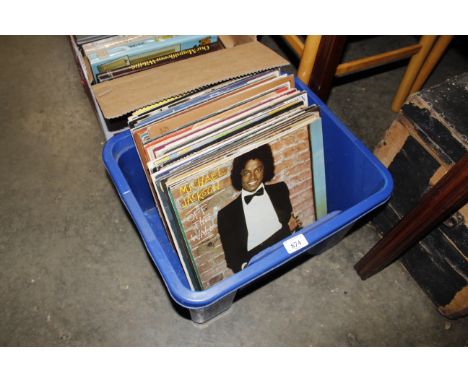 A box containing various records to include Bruce Springsteen, Michael Jackson, Dire Straits etc.