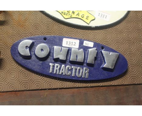 A painted oval sign for "County Tractor" (202)