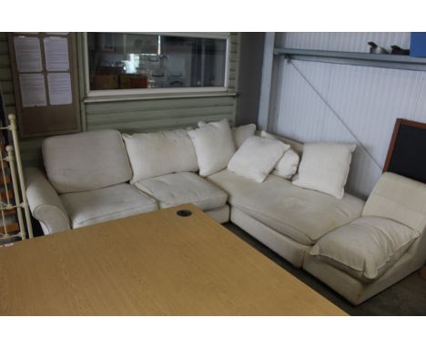 A cream upholstered corner sofa