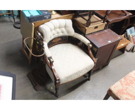 An Edwardian button back upholstered tub chair