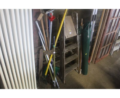 A quantity of long handled tools to include rakes, garden shears, telescopic long arm pruners etc.