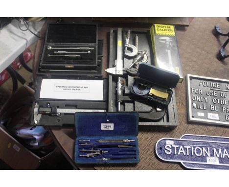 A quantity of various engineering tools to include two digital callipers, various micrometres one in fitted wooden case, draw