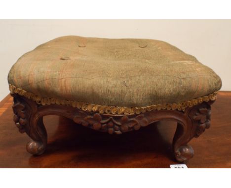 A Victorian carved walnut square foot stool with button top 