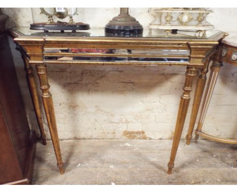 Gilt and mirrored shaped console table standing on turned legs 48" wide 