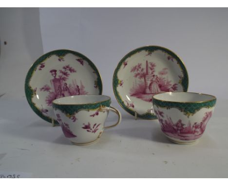 Pair of 19th century Meissen cups and saucers decorated with pastoral scenes and figures in period costume in puce within gre
