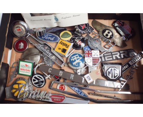 Large collection of car badges and insignia to include Bentley, Ford, RAC, MG, Cortina, Mini etc. together with a small bookl