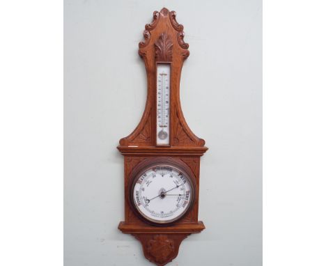 Edwardian wall barometer in carved light oak case 