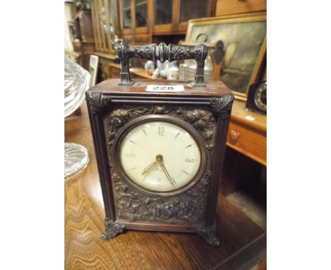 Mantel clock with carry handle in a mahogany case decorated with metal panel 