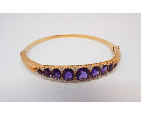 18ct yellow gold amethyst and diamond ladies hinged bangle in the antique style set 9 oval amethysts of good colour with bril