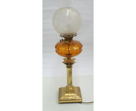 A Victorian brass corinthian column oil lamp with amber glass bowl and engraved shade converted to electricity 30" high overa