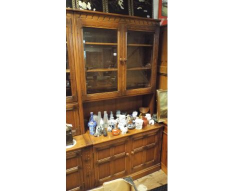 3' Ercol honey oak glazed bookcase on cupboard base 