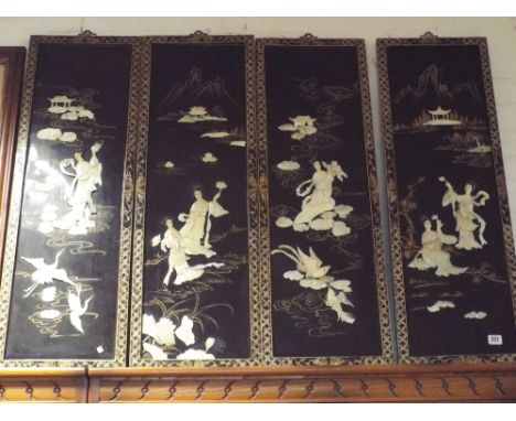 Set of four Japanese black lacquer and mother of pearl inlaid wall plaques 