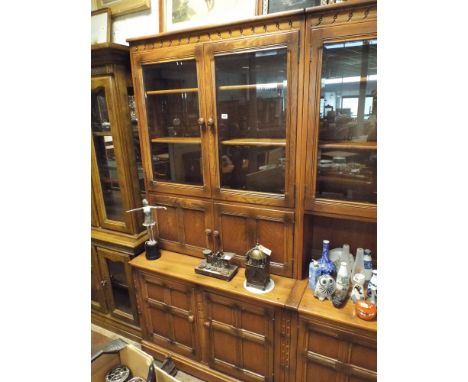 3' Ercol honey oak glazed bookcase with cupboard under standing on cupboard base 