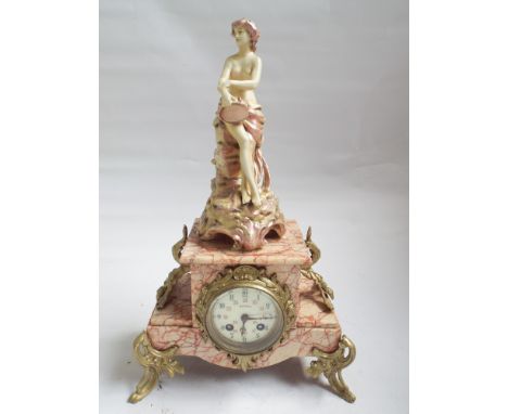 French striking mantel clock in marble and gilt mounted case with associated figure over 