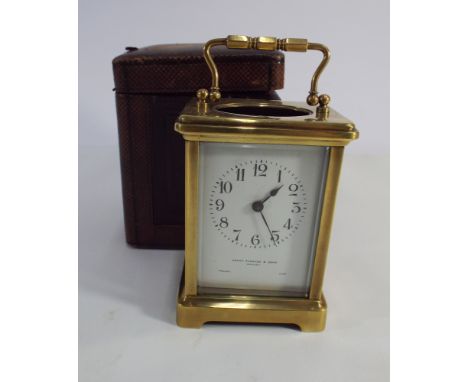 Brass French carriage clock with white enamel dial marked Henry Pidduck & Sons Hanley together with its leather carry case 