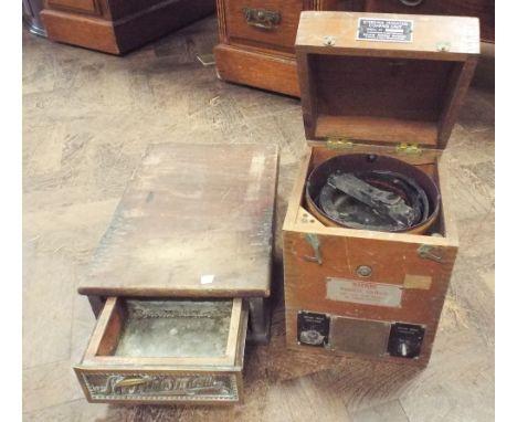 An old steering compass and the base of a national cash till fitted drawer 