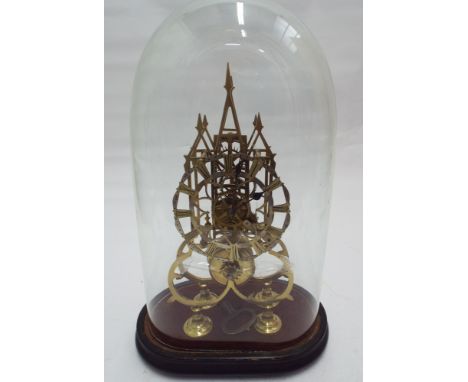 Brass skeleton clock under glass dome      Dome is in good condition