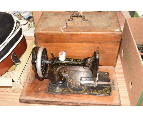 A wooden cased Singer sewing machine Together with a red painted tin trunk. 