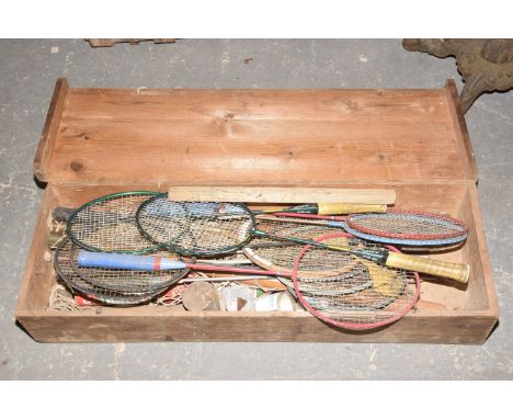 A Collection of badminton rackets and effects to a pine trunk. 
