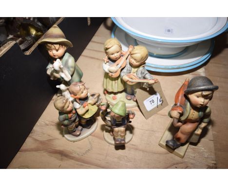 A group of five Hummel figuresThe figures in typical glaze depicting young children playing, looking after lambs, playing ins