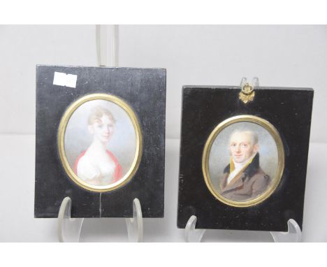 A pair of portrait miniatures The miniatures depicting lady smartly dressed and gentleman in coat. 