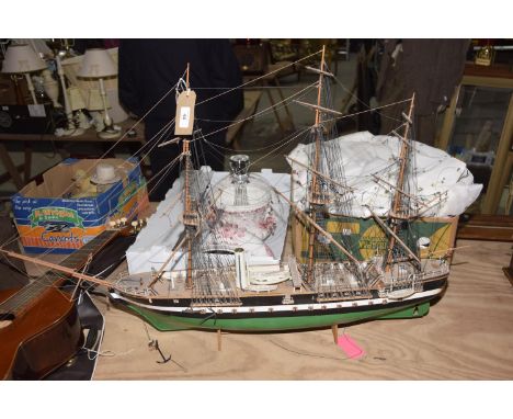 A model of a Spanish galleon With three masts and canon holds. 