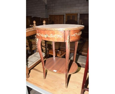 A Louis XVI style occasional table, mid 20th CenturyThe oval cross banded top with a gilt metal border above a frieze adorned