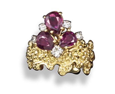 A ruby and diamond abstract gold ring, set with three pear-shaped rubies and five circular-cut diamonds set in platinum and t