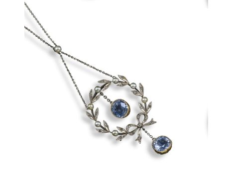 An Edwardian sapphire and diamond pendant, the pearl and diamond laurel wreath suspending two cushion-shaped sapphires in pla