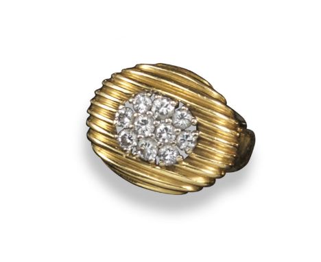 A oval-shaped diamond plaque ring, of fluted design and set with a cluster of circular-cut diamonds in yellow gold. Stamped 7