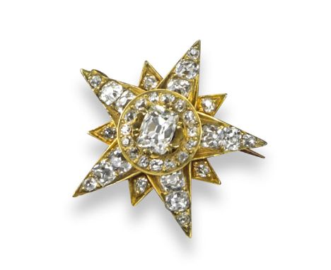 A Victorian gold star brooch, set with an old mine cut diamond set within borders of graduated old cushion-shaped diamonds in