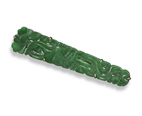 A pierced and carved jade brooch, gold mount. 6.5cm long. Accompanied by report number 5777/8108 from GCS London stating that