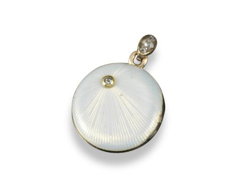 A circular gold and enamel Russian locket pendant circa 1900, with oyster coloured guilloche enamel and set with an old circu