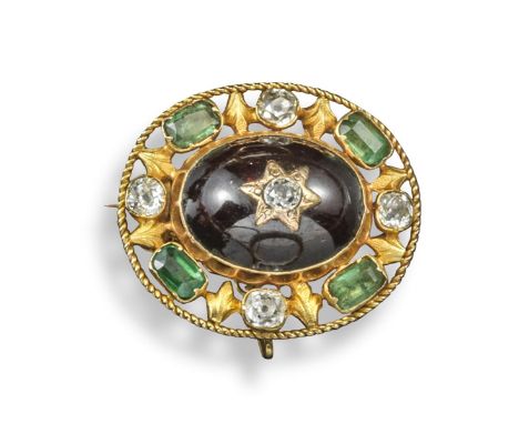 A 19th century emerald, diamond and garnet brooch, the large cabochon garnet is set within a surround of cushion-shaped diamo